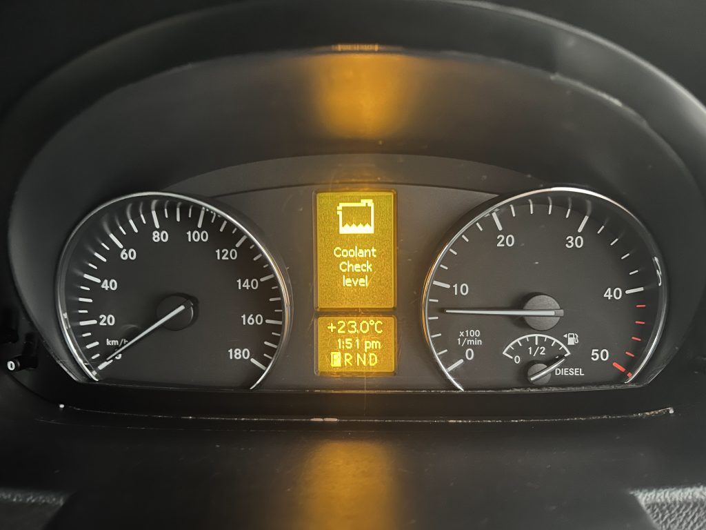 coolant warning light on the dashboard of a mercedes