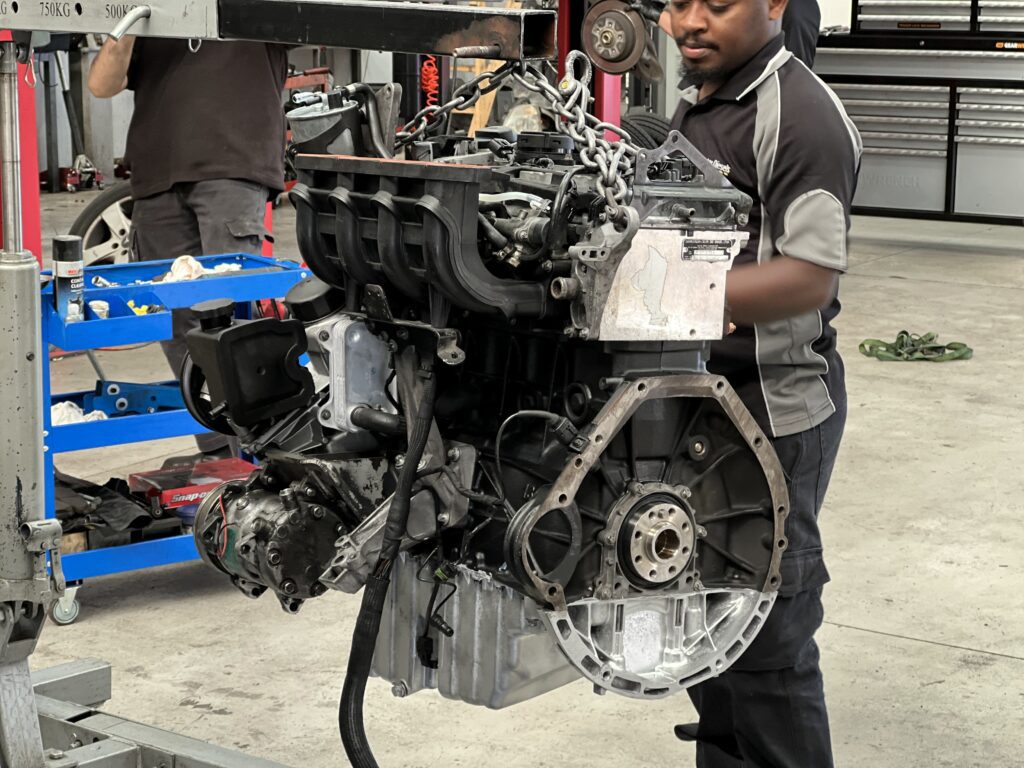 Technician preparing rebuilt mercedes sprinter engine OM611