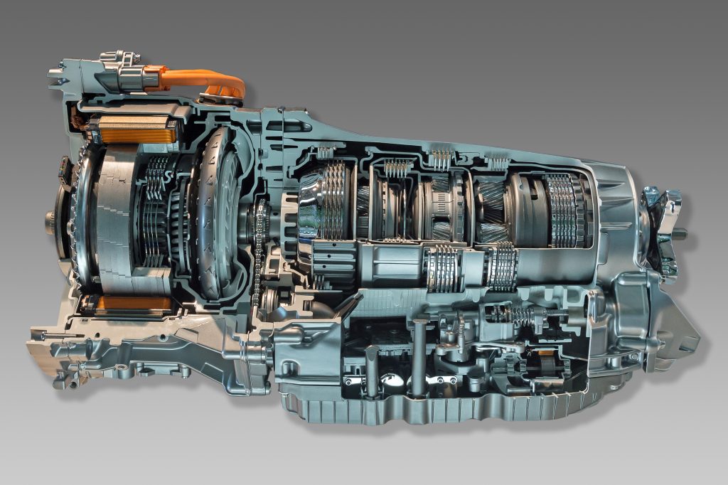 A detailed cross-sectional view of an automatic transmission system, showcasing its internal components such as gears, clutch assemblies, and hydraulic systems against a gradient grey background. The image reveals the intricate mechanical structure and engineering, akin to the precision found in fuel injector repairs.