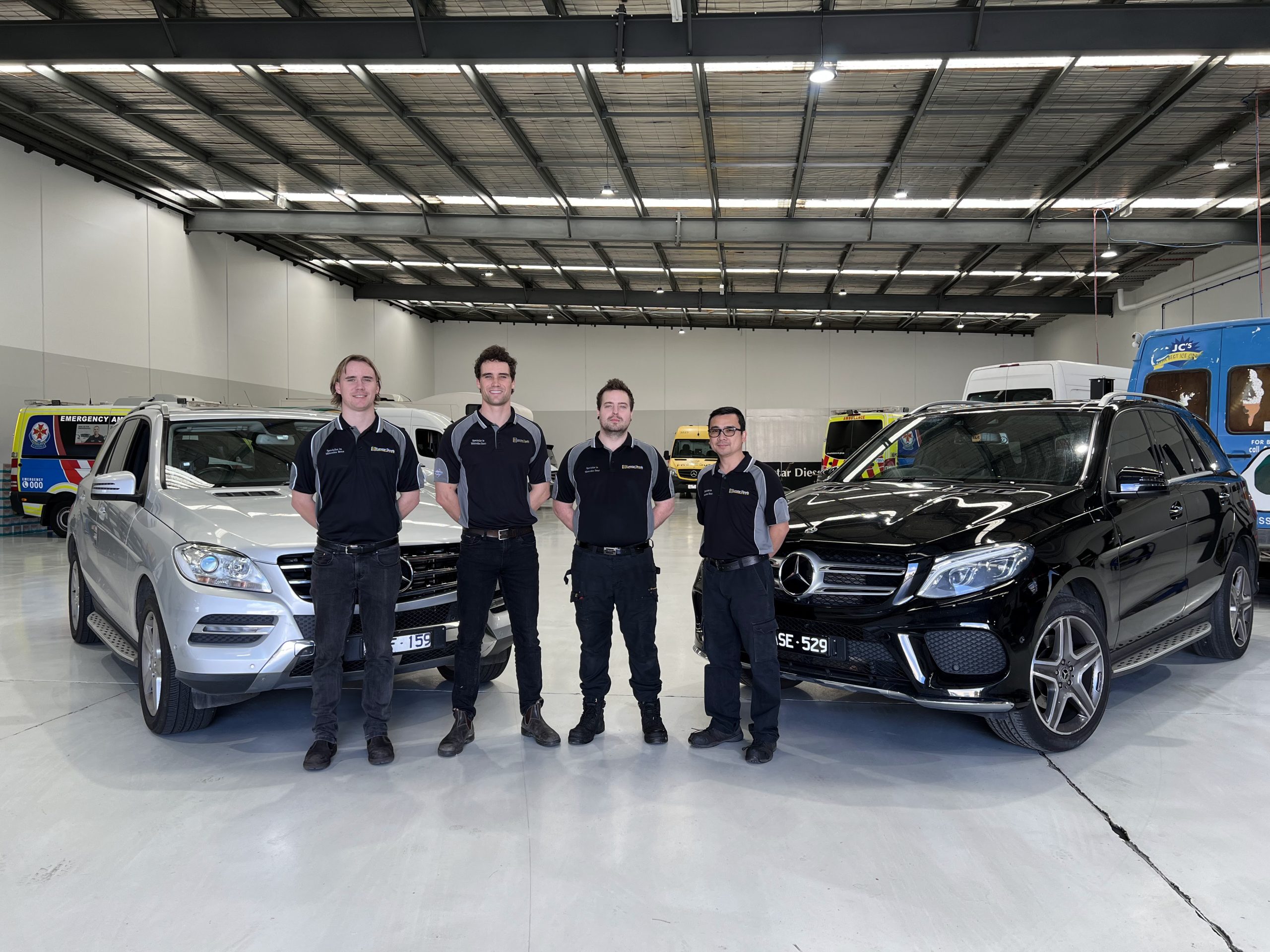eurostar technicians in front of mercedes cars
